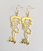 Load image into Gallery viewer, Gold earrings with intricate Betty boop designs on a light gray background
