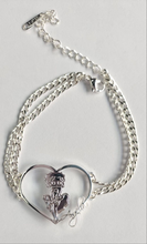 Load image into Gallery viewer, A double-layered silver chain bracelet with a heart-shaped pendant featuring the iconic Betty Boop character.