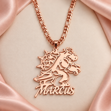 Load image into Gallery viewer, Rose gold dinosaur cutout name pendant reading MARCUS on a Figaro chain with ivory and blush background
