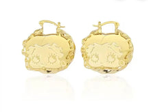 Load image into Gallery viewer, Pair of Betty Boop face gold hoop earrings with intricate designs on a white background