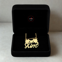 Load image into Gallery viewer, Gold necklace with Snoopy personalized pendant in a black jewelry box on a light gray background