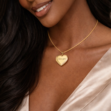 Load image into Gallery viewer, Woman wearing a gold necklace with a heart-shaped pendant that says 'I love you'.