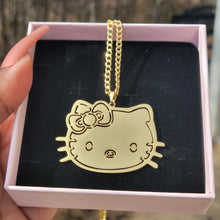 Load image into Gallery viewer, Gold Hello Kitty face-shaped pendant in a pink box