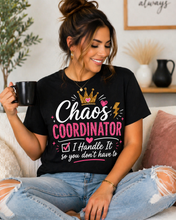 Load image into Gallery viewer, Woman wearing a black t-shirt with 'Chaos Coordinator' text, sitting on a couch.