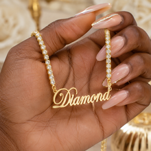 Load image into Gallery viewer, Gold tennis necklace with diamond accents held by a hand