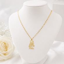 Load image into Gallery viewer, Gold necklace with Winnie on a mannequin bust with a white rose and pearls in the background
