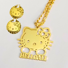 Load image into Gallery viewer, Gold Hello Kitty necklace and earrings set on a light gray background
