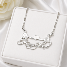 Load image into Gallery viewer, A silver necklace with a custom script name pendant and two small cats holding hearts, displayed on a white jewelry box.