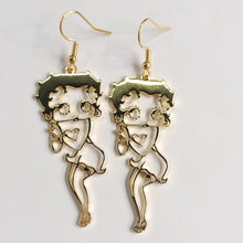 Load image into Gallery viewer, Pair of Betty Boop gold earrings with a decorative design on a light gray background