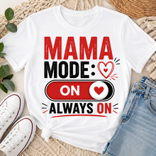 Load image into Gallery viewer, White t-shirt with 'Mama Mode: On Always On' text design on a textured surface with shoes and jeans.