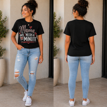 Load image into Gallery viewer, Woman wearing a black t-shirt with text and light blue jeans, standing indoors.
