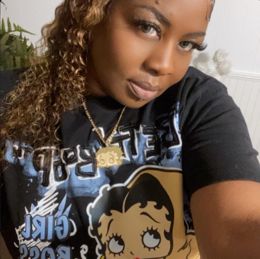 Customer wearing a gold Betty Boop necklace