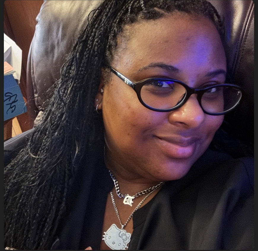 Customer wearing layered necklaces with a silver Hello Kitty pendant