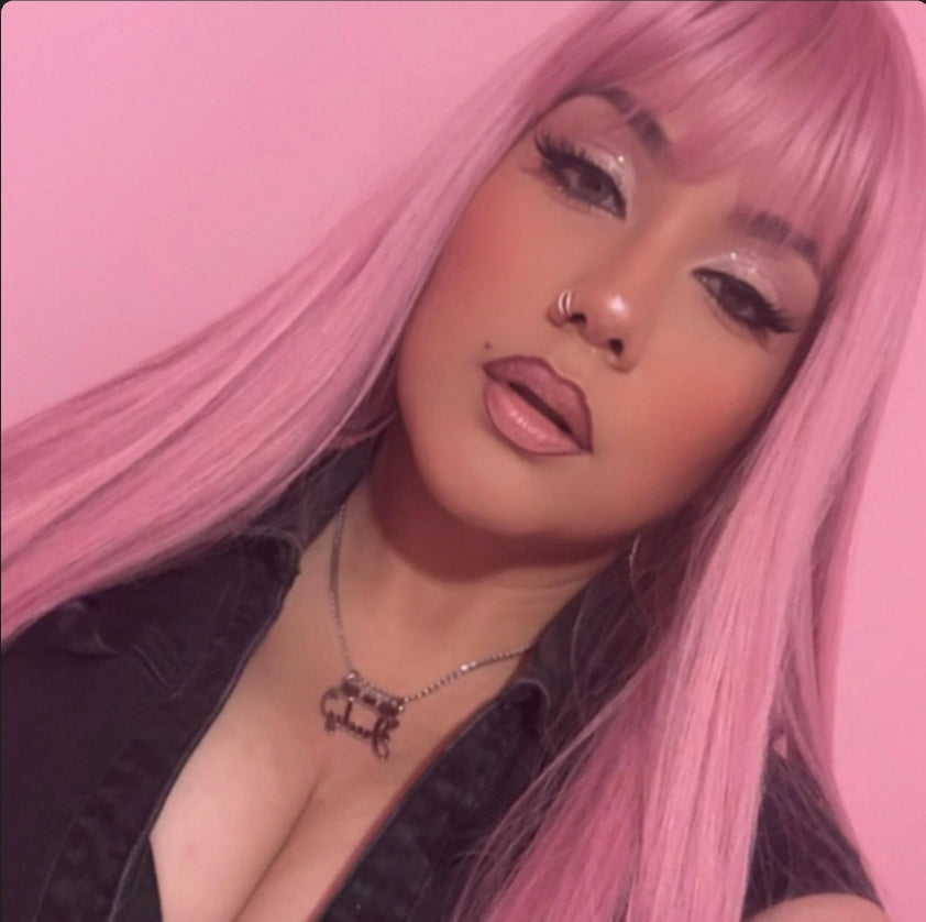 Customer with pink hair wearing her personalized necklace