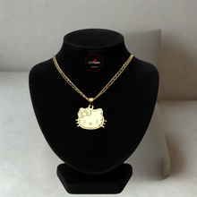 Load image into Gallery viewer, Gold necklace with a Hello Kitty pendant on a black bust against a neutral background
