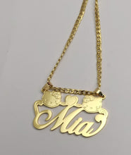 Load image into Gallery viewer,  A gold necklace with a pendant featuring the name 'Mia' in a cursive script. The pendant is flanked by two Hello Kitty charms and a heart charm.
