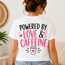 Load image into Gallery viewer, Person wearing a white t-shirt with 'Powered by Love &amp; Caffeine' text and coffee cup graphic.

