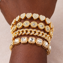Load image into Gallery viewer, Gold bracelets with diamond accents on a wrist against a neutral background

