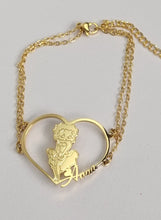 Load image into Gallery viewer, Gold Betty Boop bracelet with a heart-shaped pendant featuring character on a gray background
