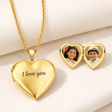 Load image into Gallery viewer, Gold heart-shaped locket with 'I love you' engraving and two heart compartments with photos on a white background.
