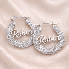 Load image into Gallery viewer, Silver hoop earrings with zirconia stones with the name 'Robin' engraving on a soft pink background
