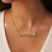 Load image into Gallery viewer, Gold necklace with 'HMU Ladies' with Betty Boop face at the end of pendant on a person wearing a white top.
