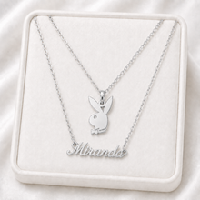 Load image into Gallery viewer, Silver necklace with Playboy bunny pendant and 'Miranda' engraving on a white display box.
