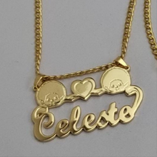 Load image into Gallery viewer, Gold Monchhichi necklace with 'Celeste' pendant on a gray background
