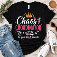 Load image into Gallery viewer, Black t-shirt with 'Chaos Coordinator' design on a wooden surface with jeans and shoes.
