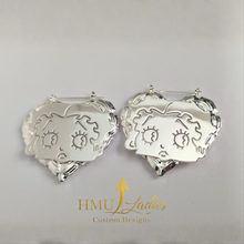 Load image into Gallery viewer, Betty Boop Silver heart-shaped earrings with intricate designs on a gray background, featuring the brand 'HMU Ladies'.
