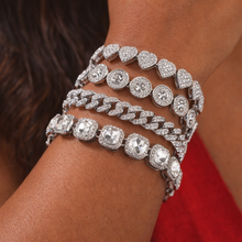 Load image into Gallery viewer, Close-up of a wrist wearing multiple diamond-encrusted bracelets on a blurred background.
