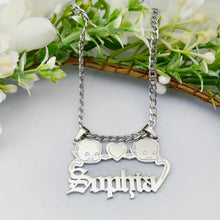 Load image into Gallery viewer, Silver necklace with Kewpie personalized with the name'Sophia' pendant on a light background with flowers

