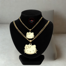 Load image into Gallery viewer, Gold necklaces with Hello Kitty pendants on a black bust against a neutral background

