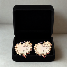 Load image into Gallery viewer, Gold Hello Kitty heart shaped earrings in a black jewelry box on a light gray background
