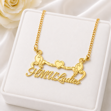 Load image into Gallery viewer, A gold-tone necklace with a custom script pendant reading 'HMU Ladies' and two cats figures holding a heart, displayed on a white jewelry box.
