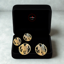 Load image into Gallery viewer, Set of gold Minnie Mouse earrings in a black box on a light gray background
