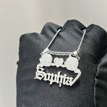 Load image into Gallery viewer, Silver necklace two babies with the name'Sophia' pendant on a black fabric background
