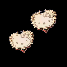Load image into Gallery viewer, Gold Hello Kitty earrings on a black background
