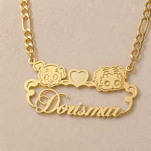 Load image into Gallery viewer, Gold necklace with 'Dorismar' and cartoon Pudgy &amp; Betty Boop character designs on a beige background
