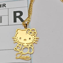 Load image into Gallery viewer, Gold Hello Kitty pendant on a chain against a gray background with a label.

