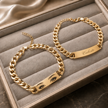 Load image into Gallery viewer, Custom gold engraved eye bracelet with personalized Celeste nameplate on luxury beige jewelry display tray
